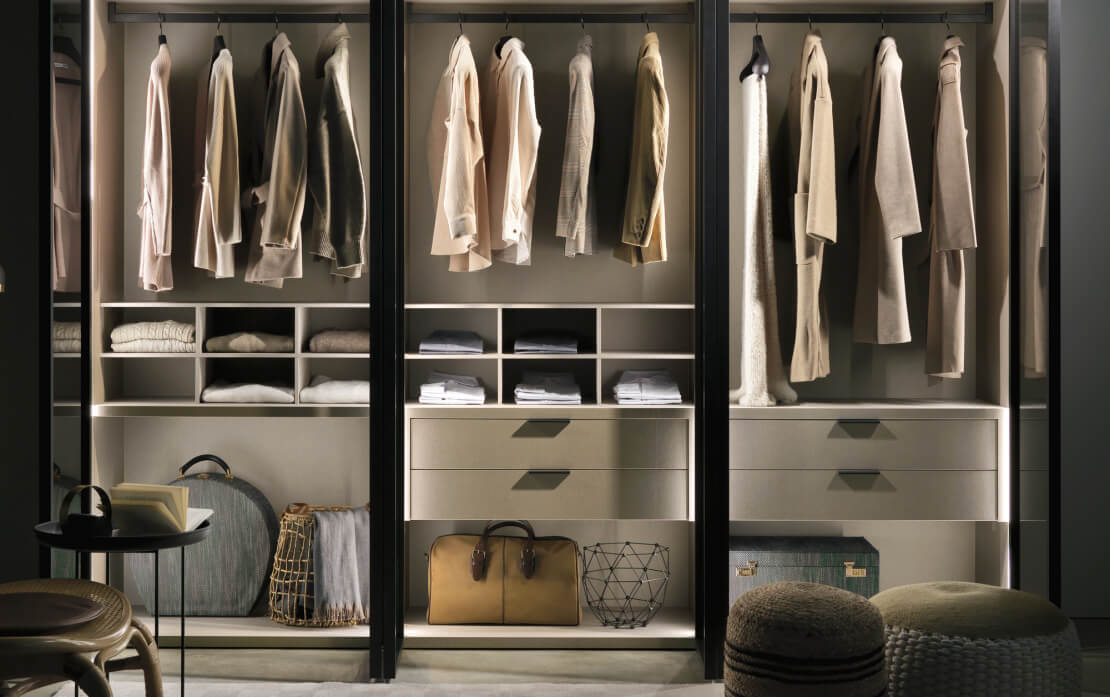 Alterna hinged wardrobe with fumé glass City Glass door and burnished frame, slate external side, sesame shirt tray and drawer units.